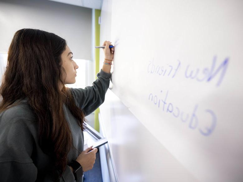 Student writing on white board