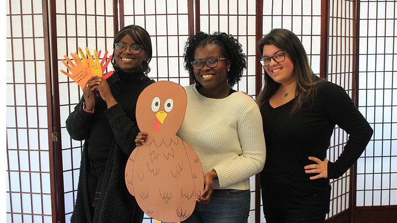 students holding a turkey